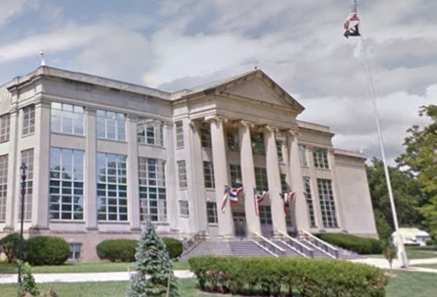 Historic county courthouse with columns and American flags